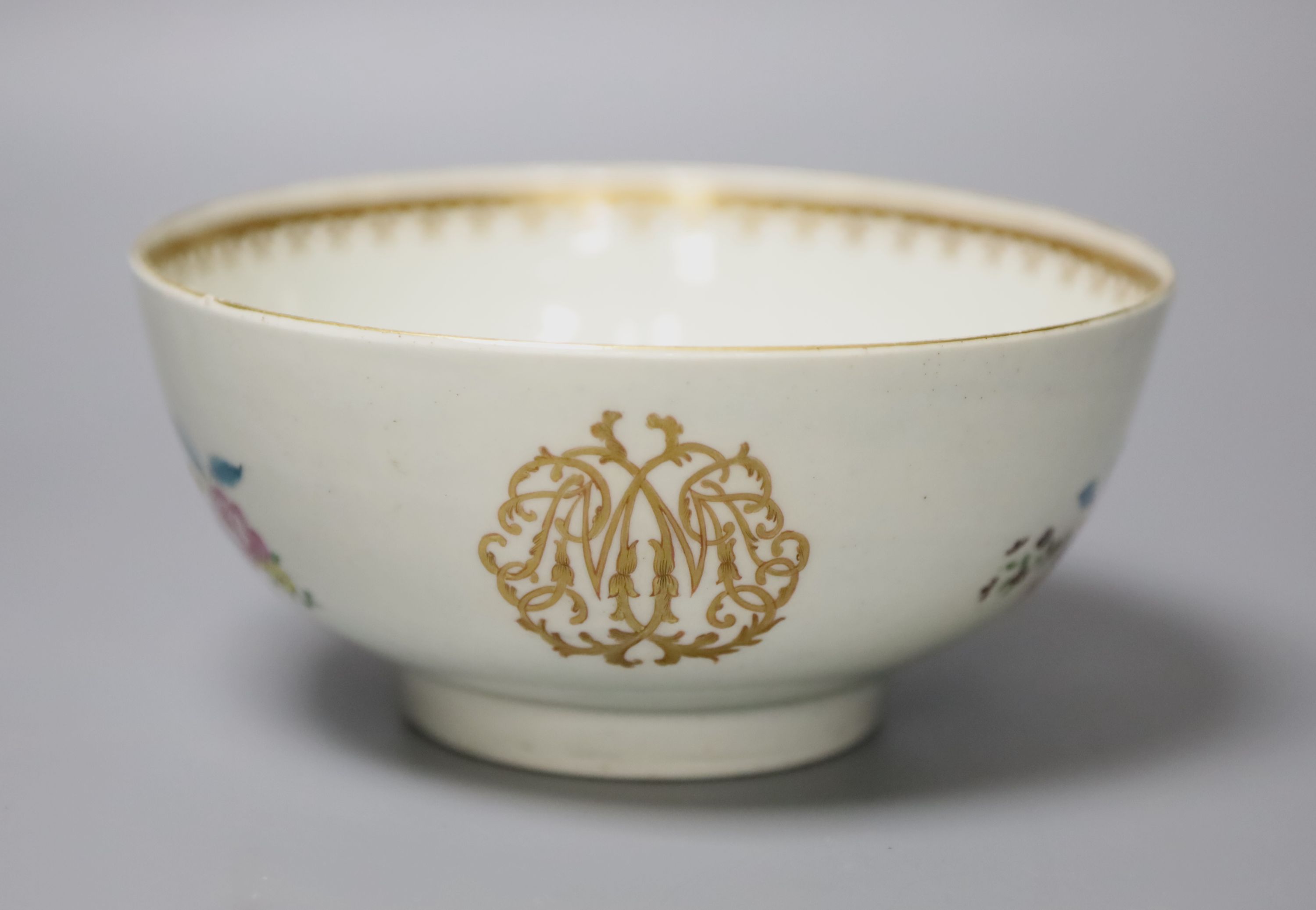 An 18th century Worcester bowl painted with coloured flowers gilded and outlined in red with initials, diameter 15cm